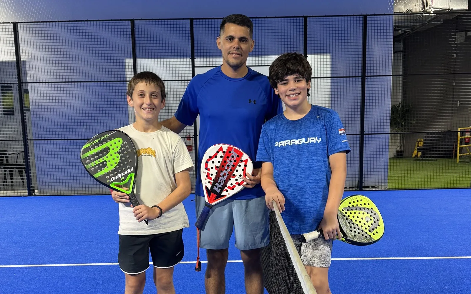 Emiliano Sosa with two students in a padel class at Padel Point, Miami Beach